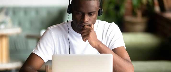 man using laptop concentrating