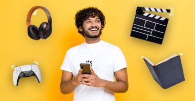 Man with phone, headphones, games controller, clapperboard and a book