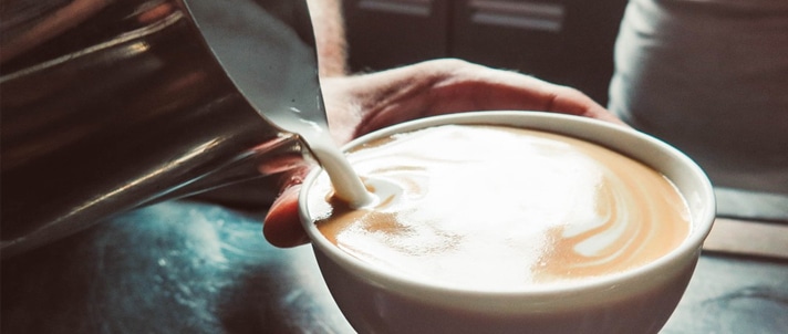 hot milk poured into coffee