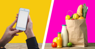 woman holding phone and bag of groceries