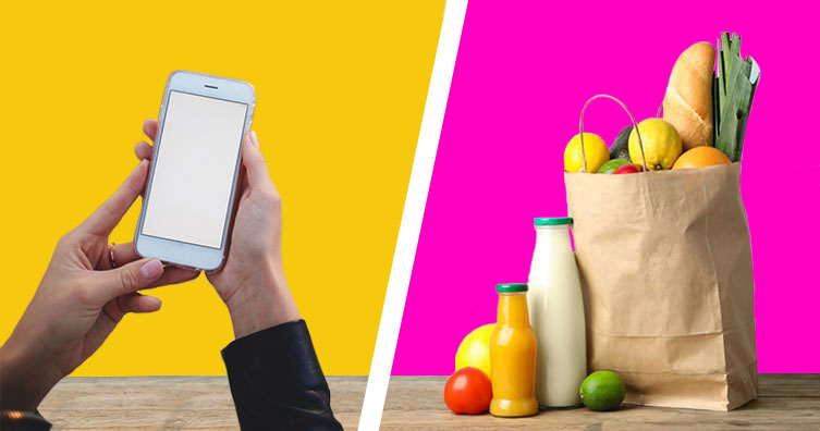 woman holding phone and bag of groceries