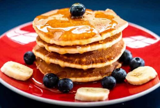stack of pancakes with fruit toppings