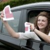 girl in car with l plate ripped
