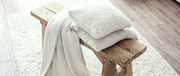 pillow and blanket on a stool