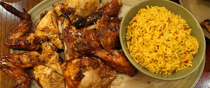 platter of chicken wings with rice on the side in a bowl at nandos restaurant