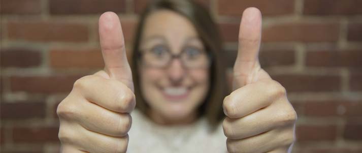 woman holding two thumbs up