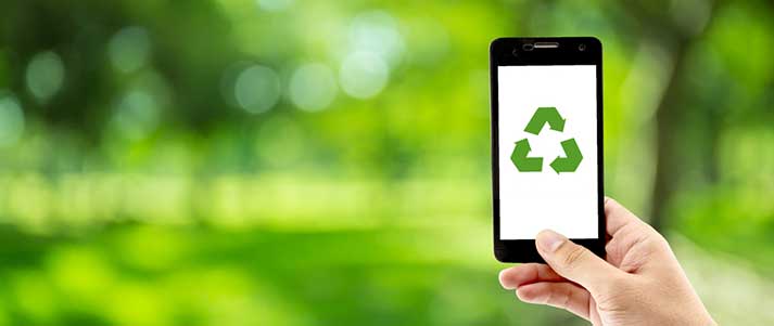 Person holding phone with recycle symbol