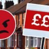 Money symbols on sign outside terraced houses