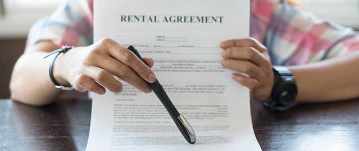 Woman with pen holding rental agreement