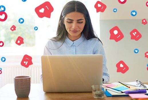 Woman on laptop with social media icons