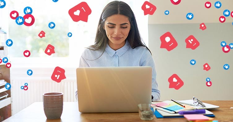 Woman on laptop with social media icons
