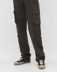 dark cargo trousers with black and white shoes