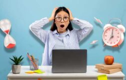 stressed student with laptop, hourglass and alarm clock