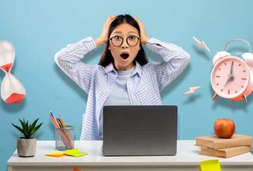 stressed student with laptop, hourglass and alarm clock