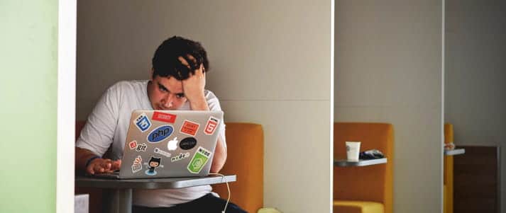 stressed student using a laptop