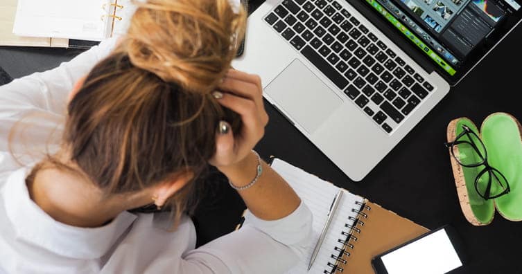 person stressed at laptop