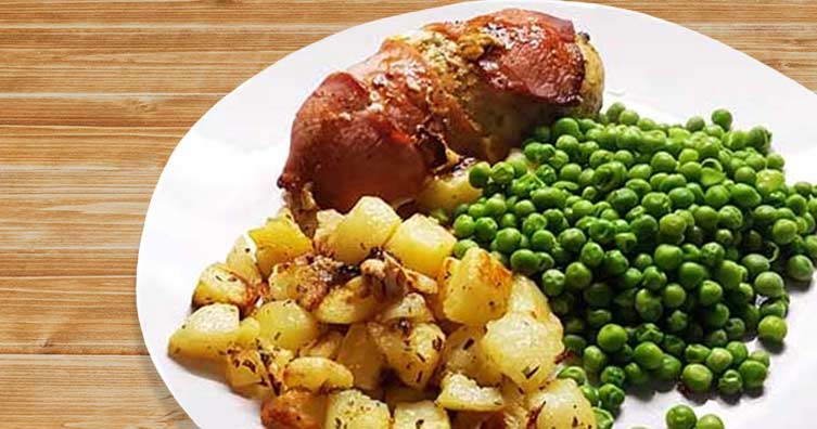 chicken wrapped in bacon with potatoes and peas