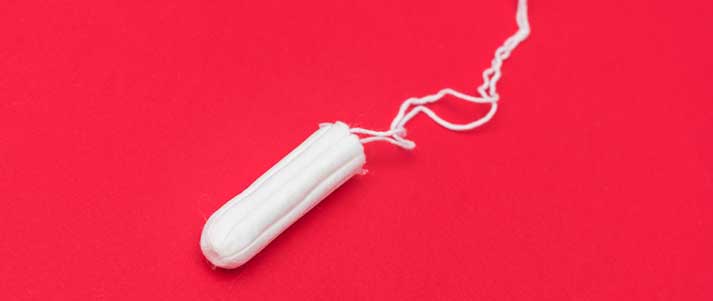 unwrapped tampon with plain background