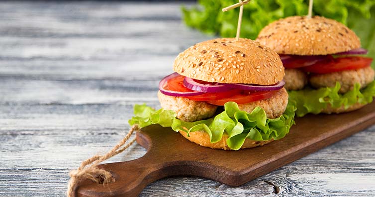 turkey burgers on wooden chopping board