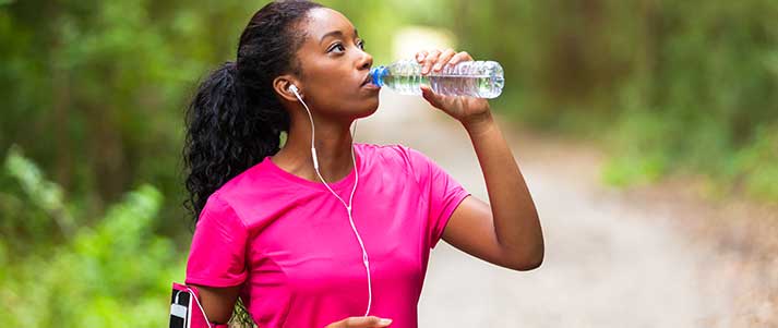 woman on run drinking water