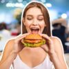 Woman eating a burger in a restaurant