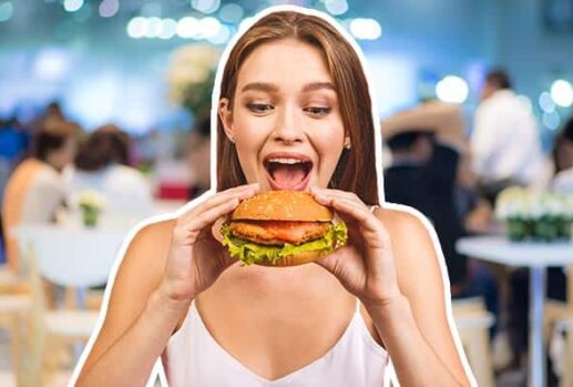 Woman eating a burger in a restaurant