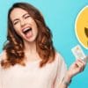 happy woman with phone and bank card with smiling money emoji