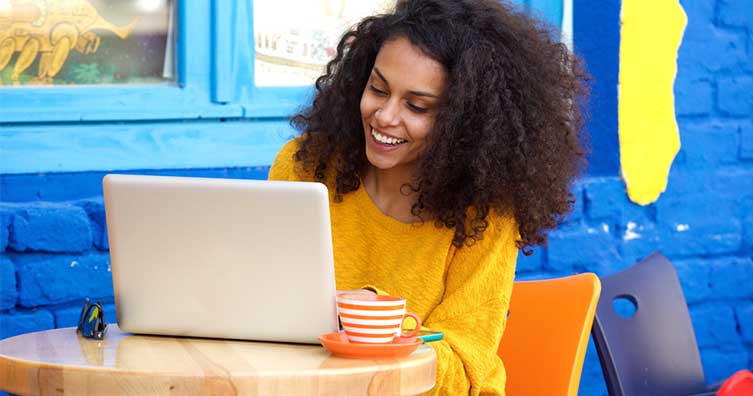 woman on laptop in colourful cafe