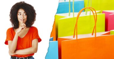 Woman shushing and colourful shopping bags
