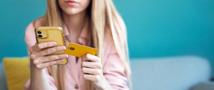 woman with card and mobile