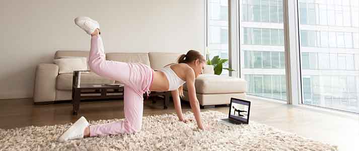 woman working out at home with an app gym
