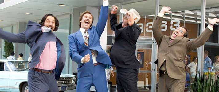 actors in anchorman celebrating outside an office
