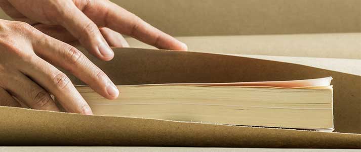 Book getting wrapped in brown paper